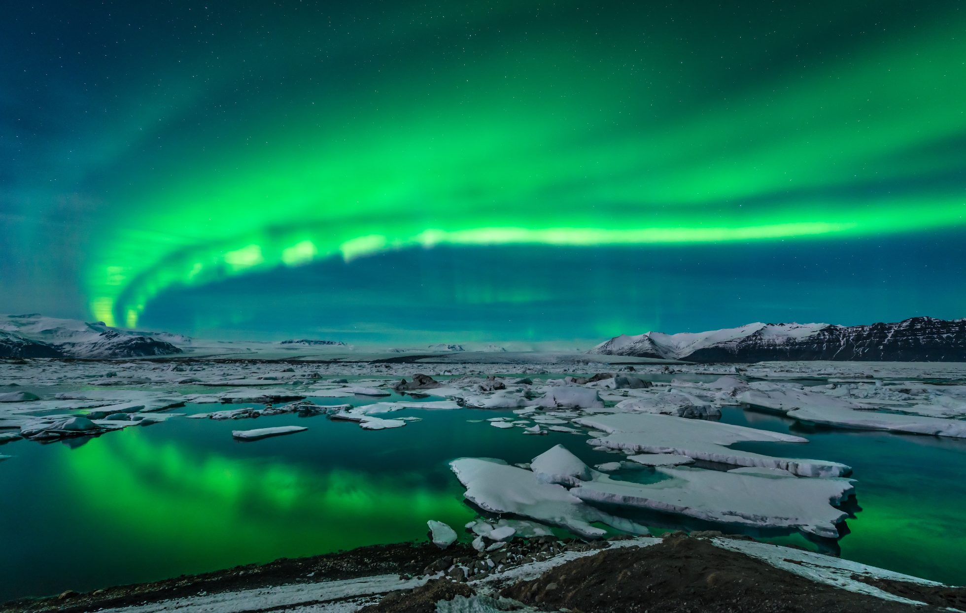 Jokulsarlon Glacier, Iceland. Water, ice, and mountains in the background.