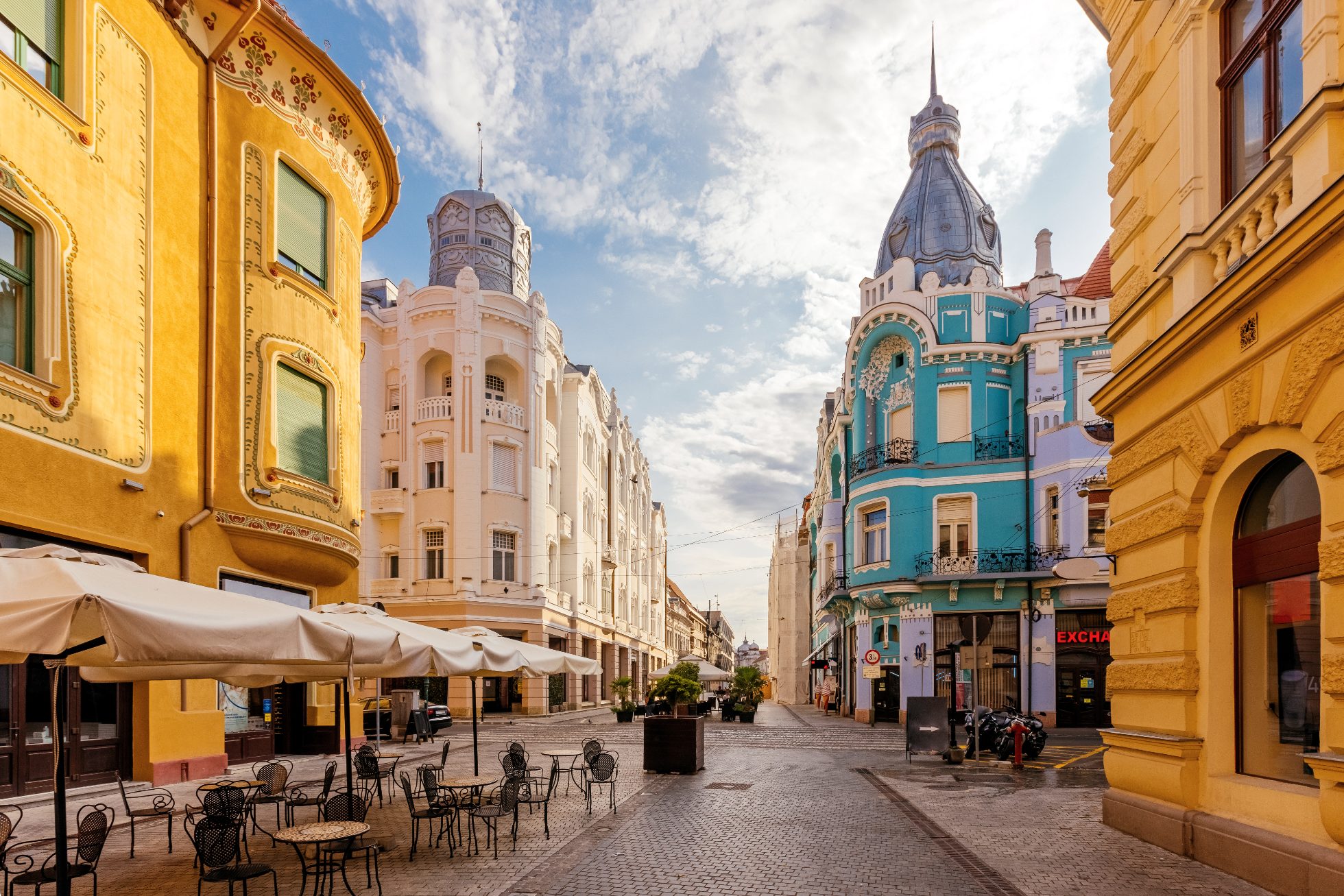 View of townhouses and streets in Oradea, Romania on a sunny day