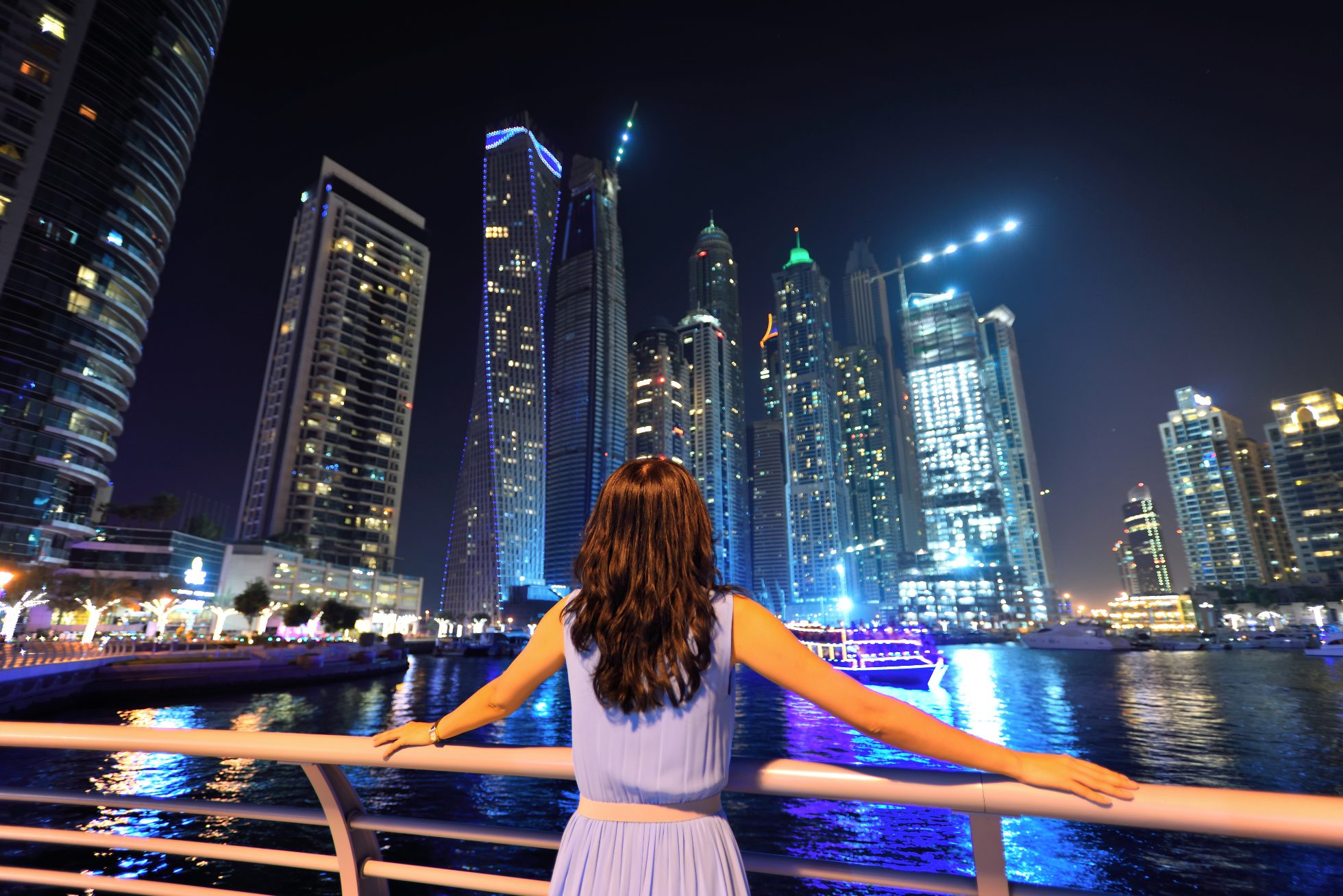 Dubai Marina skyline view featuring the yacht harbor and luxury apartment buildings.