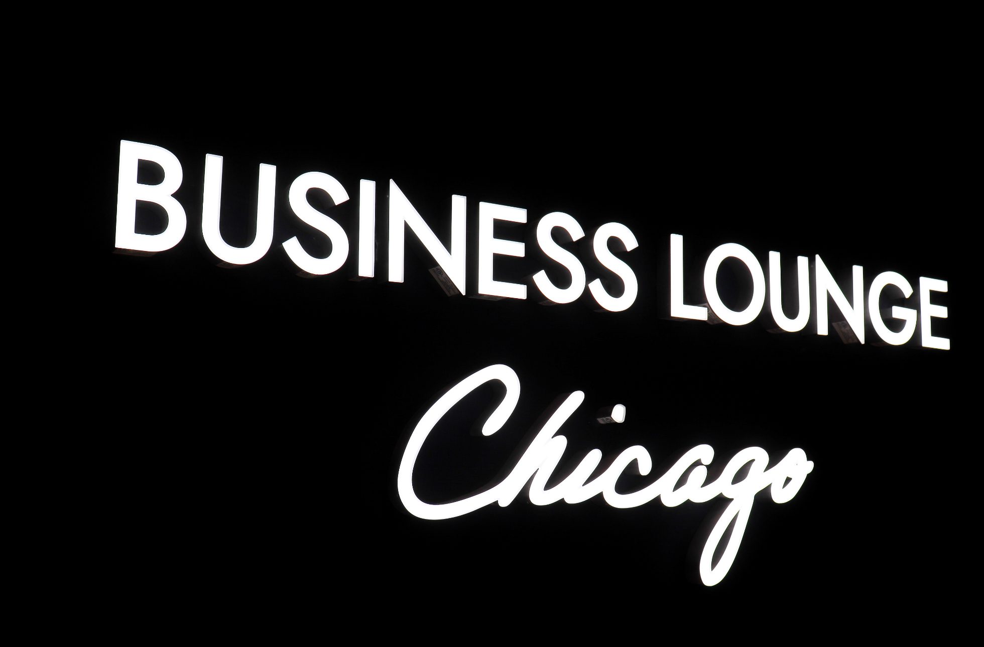 Elegant white text Business Lounge Chicago on black background