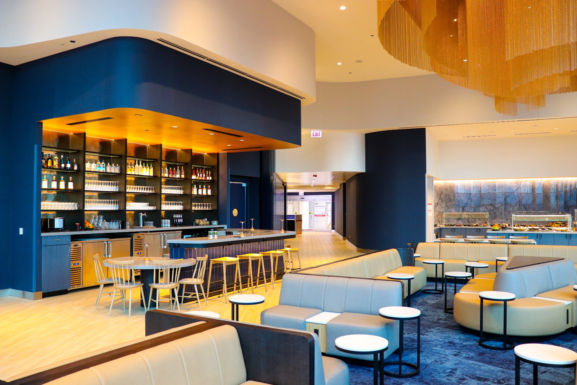 Organized and equipped business lounge bar in Chicago - side view, with comfortable sofas in front.