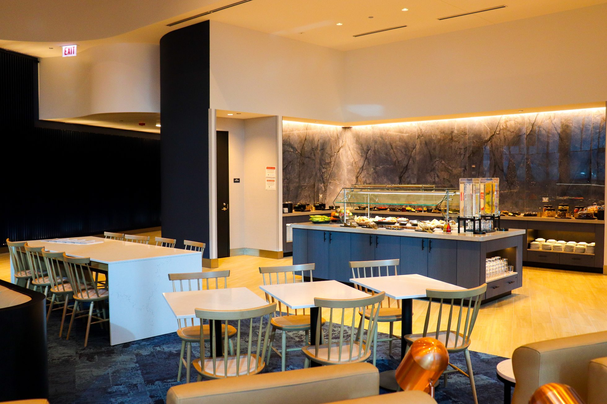 Chicago Business Lounge dining area - tables and chairs in the foreground, buffet in the background