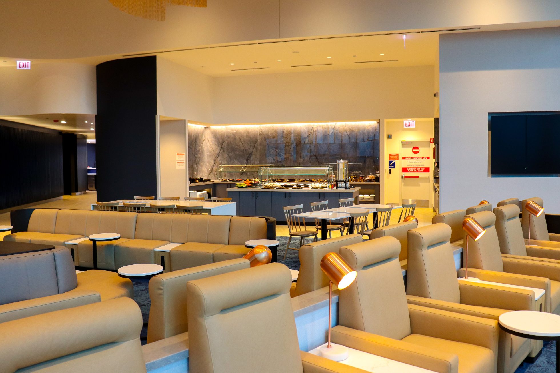 Elegant business lounge at Chicago airport. Comfortable armchairs, tables, bar, elegant lighting.