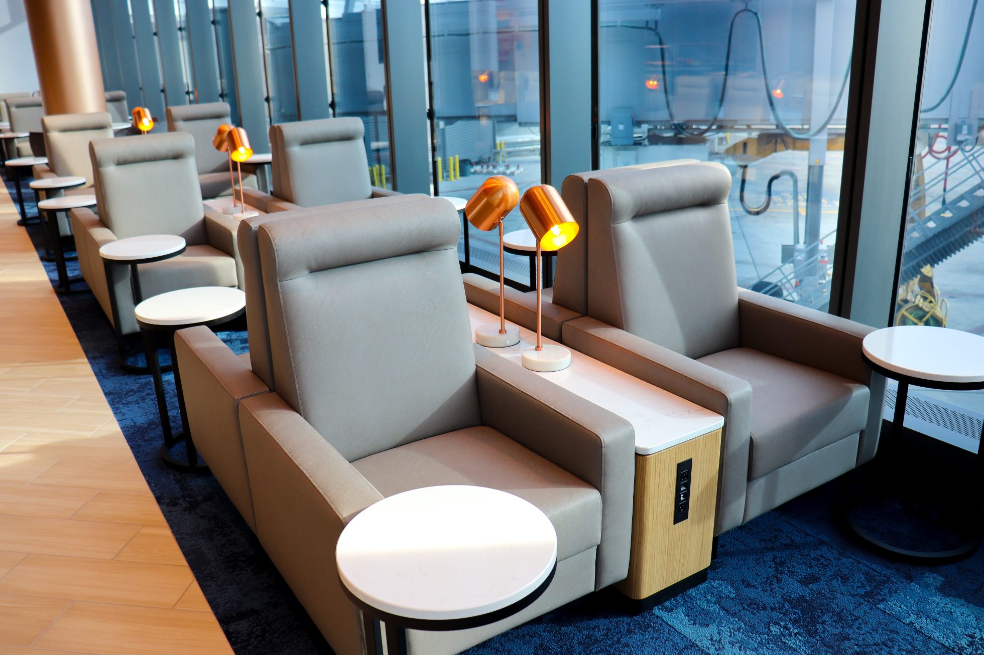 Rows of elegant double seats with power outlets between for charging electronics
