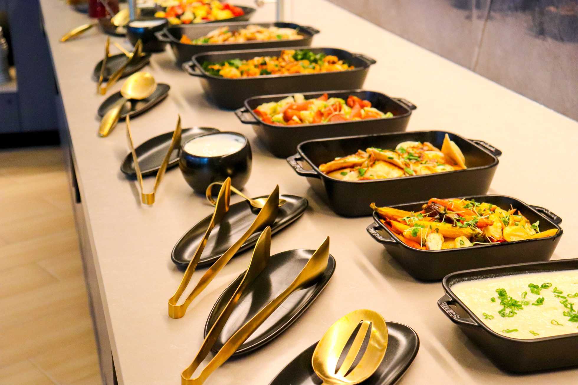 Swedish buffet with a selection of elegant dishes arranged on a long table in the Business Lounge in Chicago.
