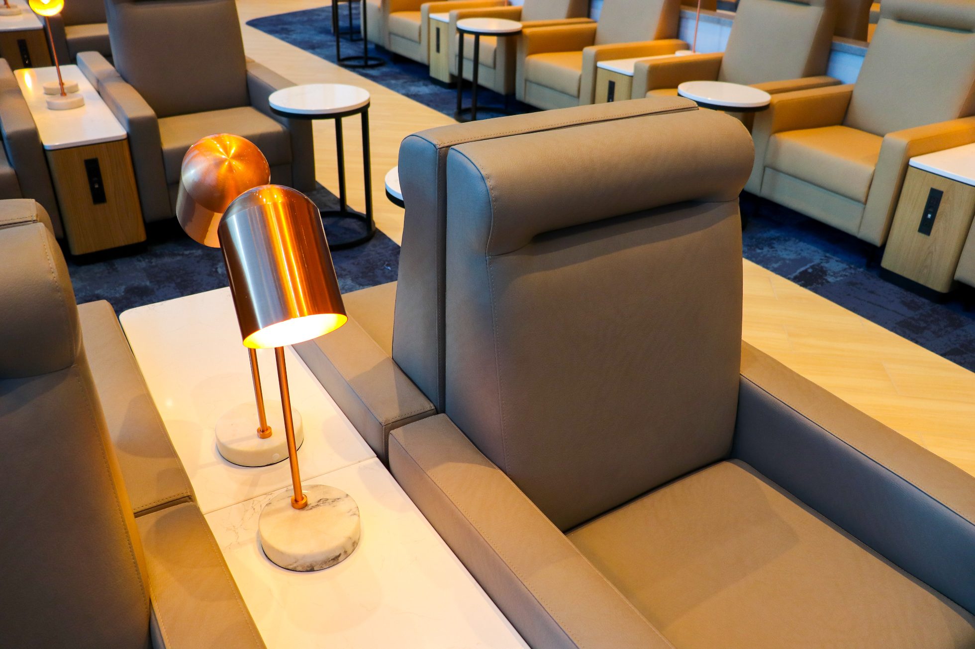 Single comfortable armchairs facing away from each other in the Business Lounge in Chicago