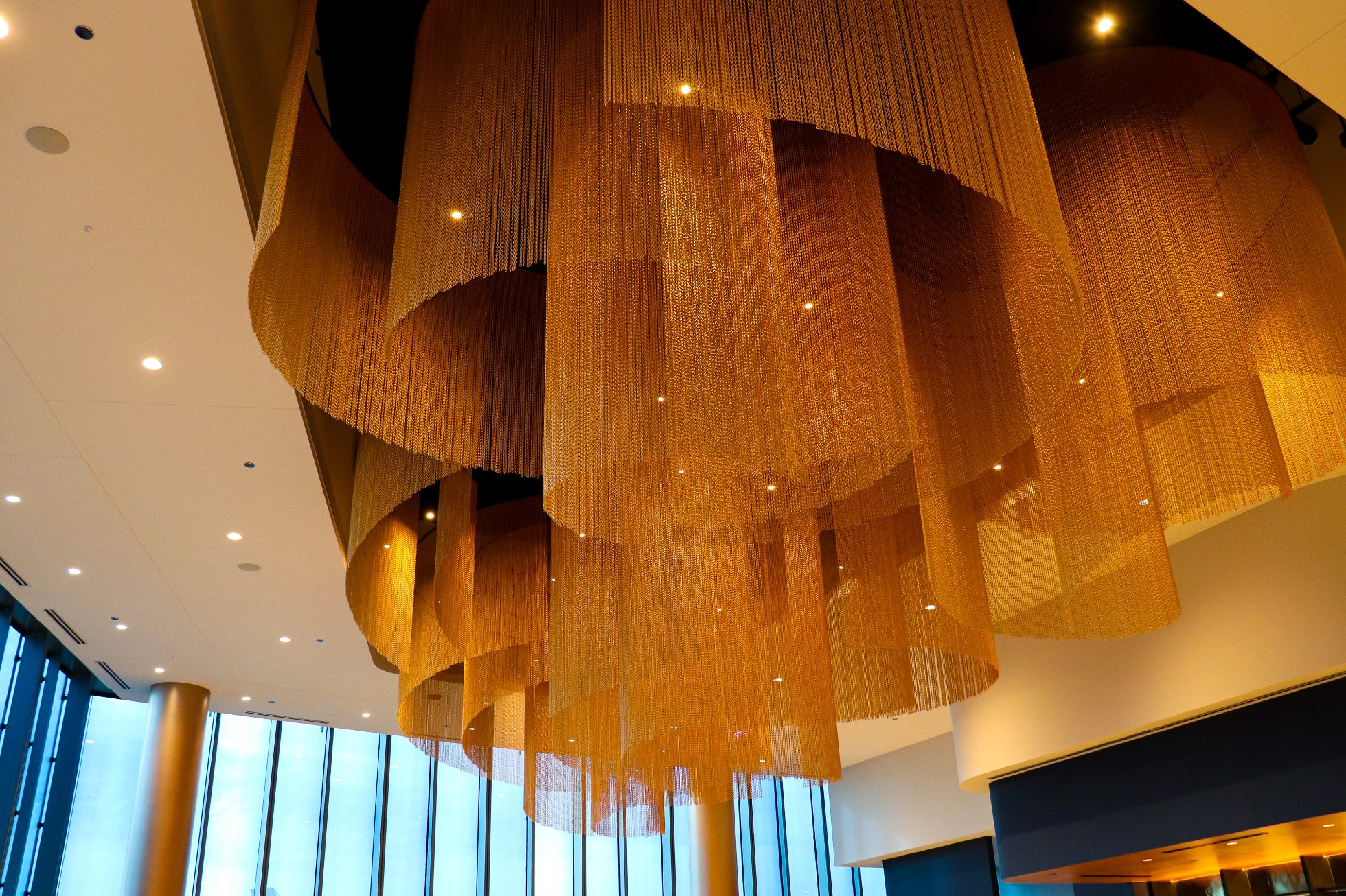 Interesting lighting arrangement with golden hanging fixtures in a circular pattern in the Business Lounge in Chicago.