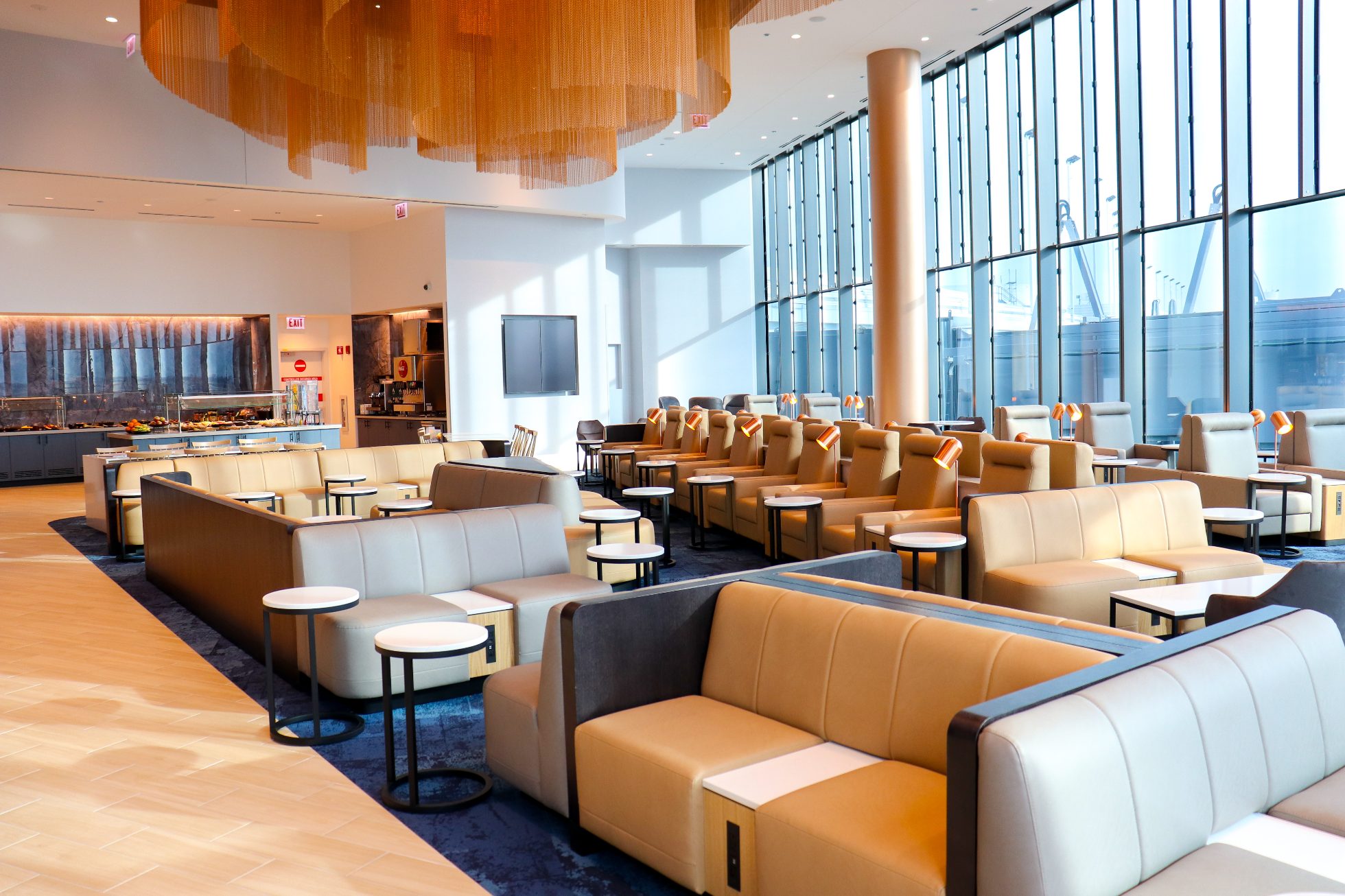 View of a spacious area in the Chicago Business Lounge, modern interior, stylish light sofas and round tables