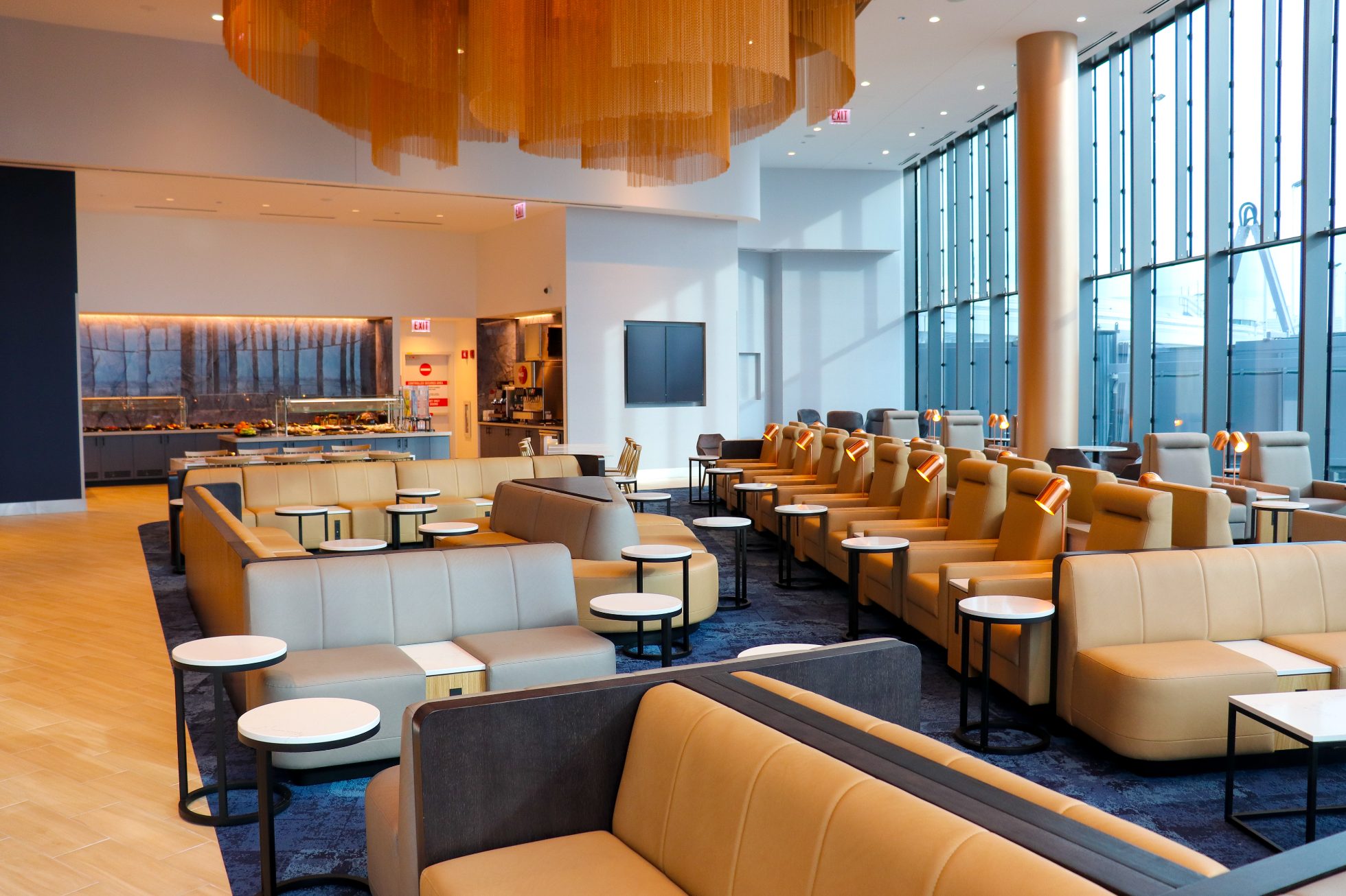 View of the space in the Business Lounge in Chicago, modern interior, stylish light sofas and round tables