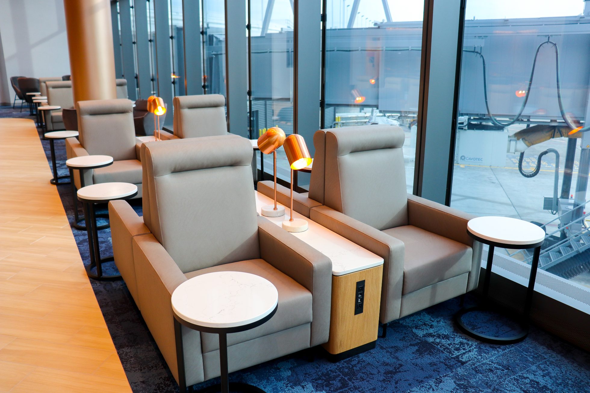 Rows of elegant double seats with power outlets between for charging electronics