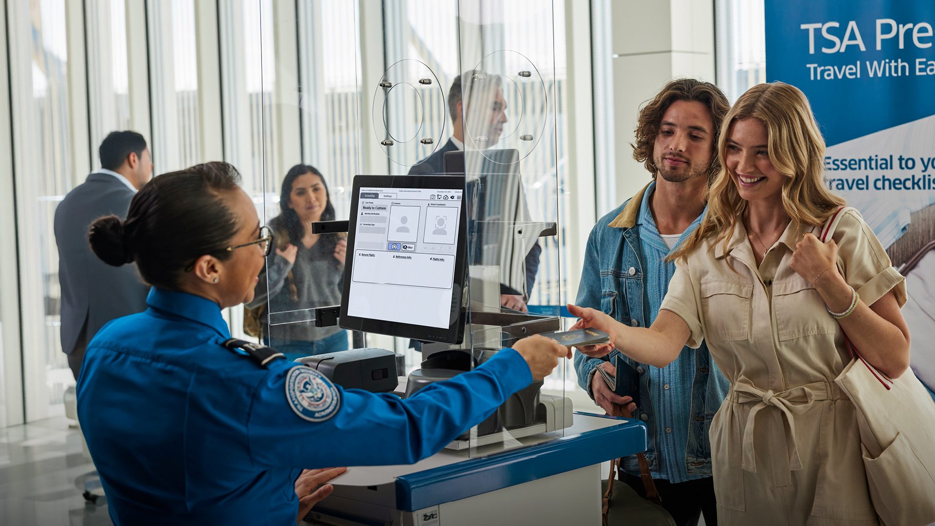 A woman and a man are going through expedited security screening at an airport in the U.S.