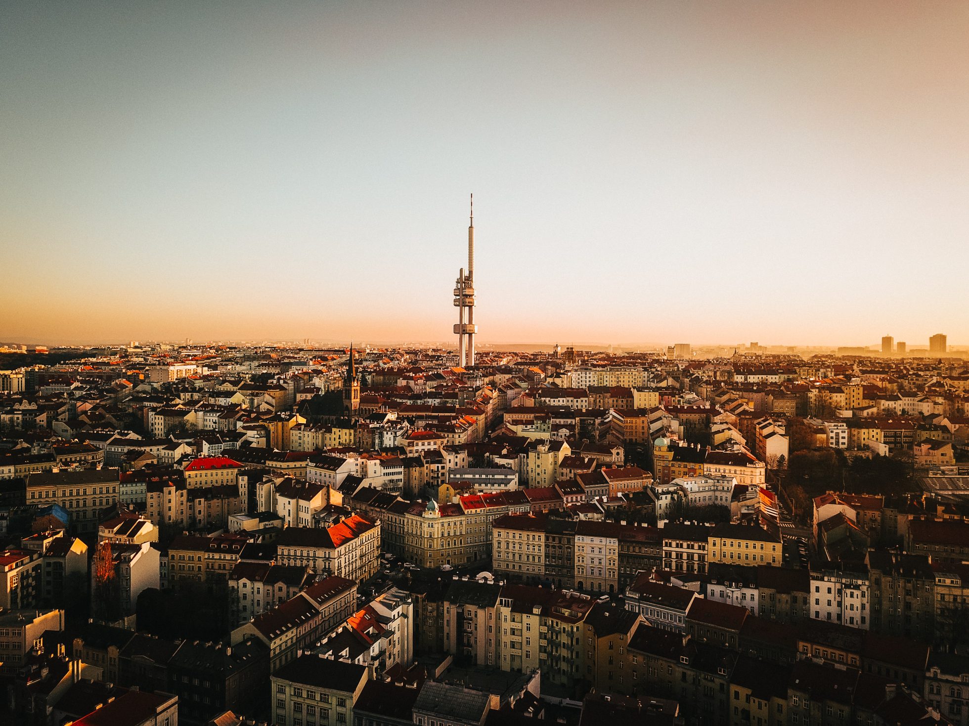 Panoramic view of Prague buildings and Zizkov Tower after sunset