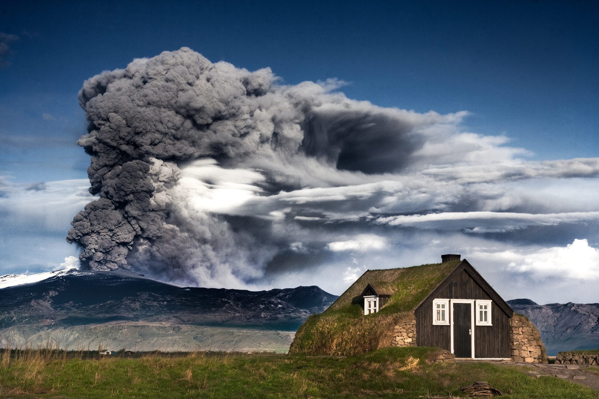 Replica of an old traditional Icelandic house from 1800 with an eruption in Eyjafjallaj