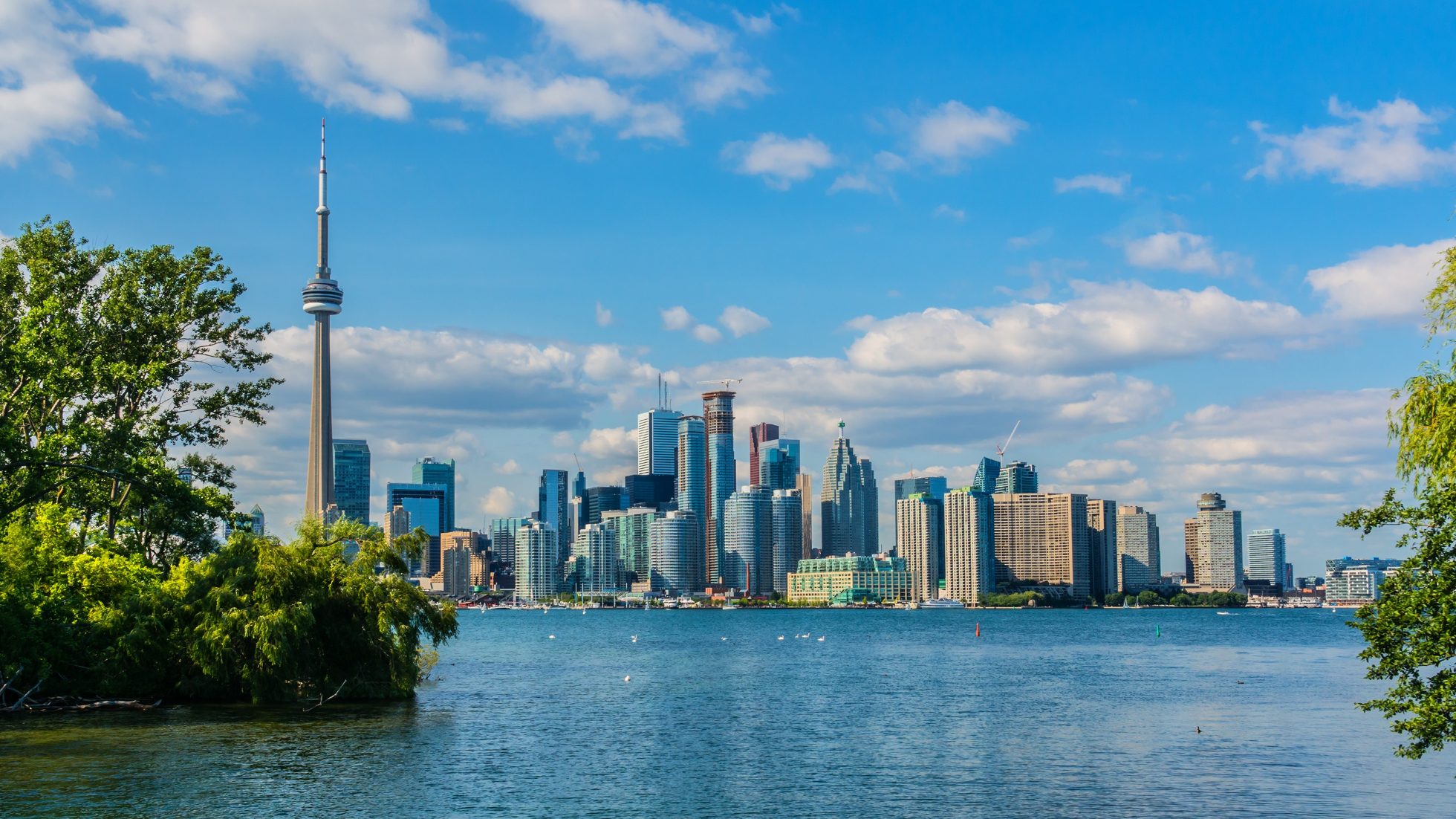 Toronto panorama with views of Lake Ontario, skyscrapers, and the CN Tower.