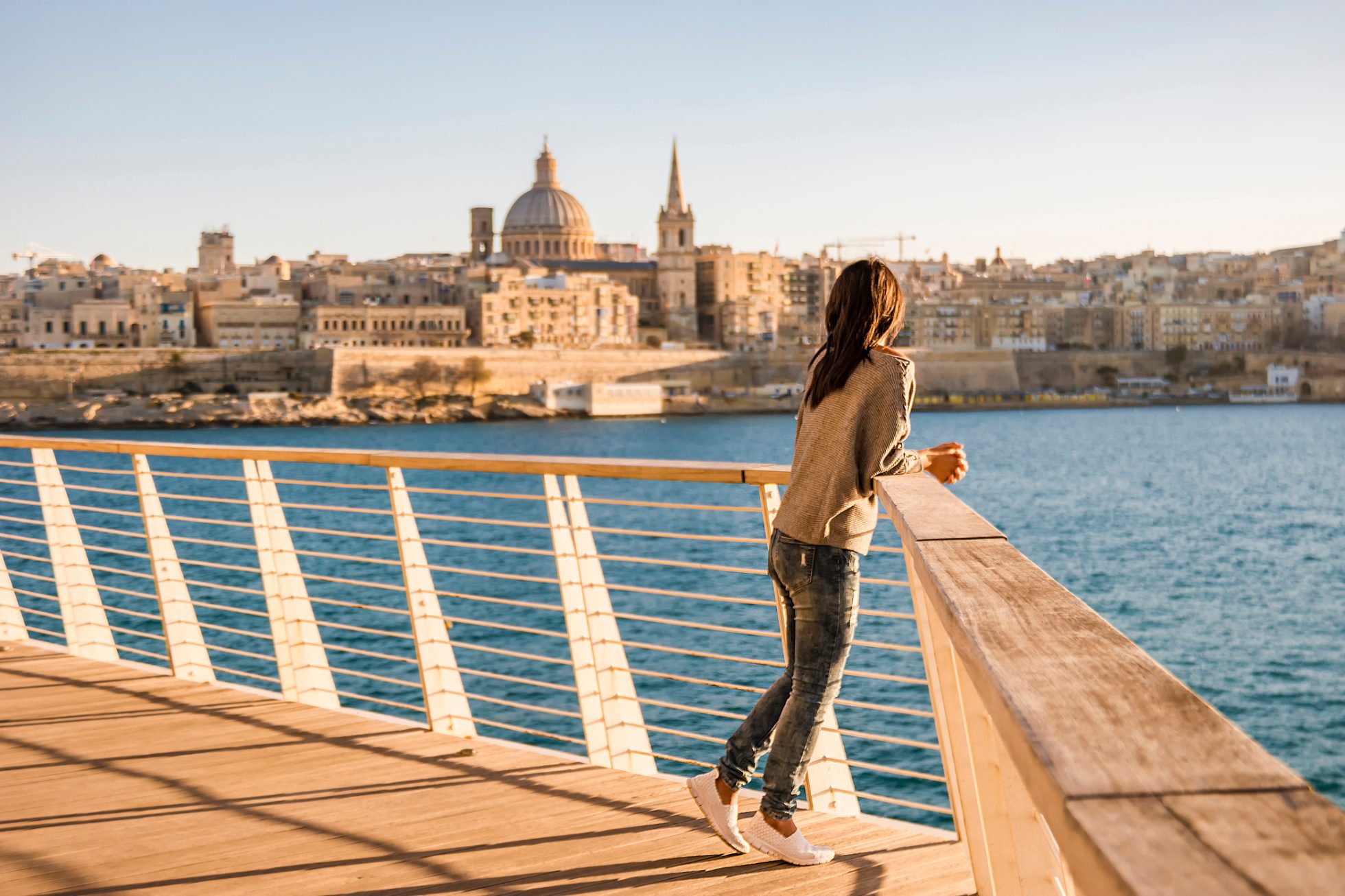 Woman looking at Malta's capital Valetta from a distance