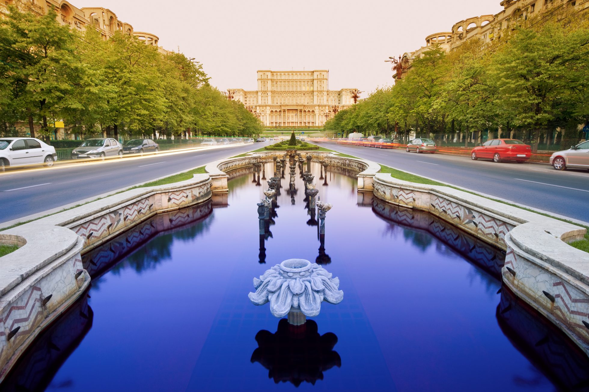 A fountain along the street against the background of parliament