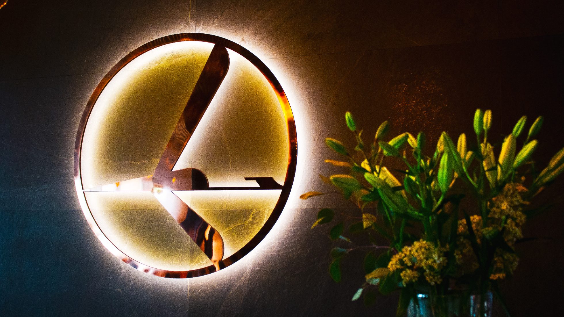 Illuminated crane logo on the wall of the LOT Business Lounge Maxurek