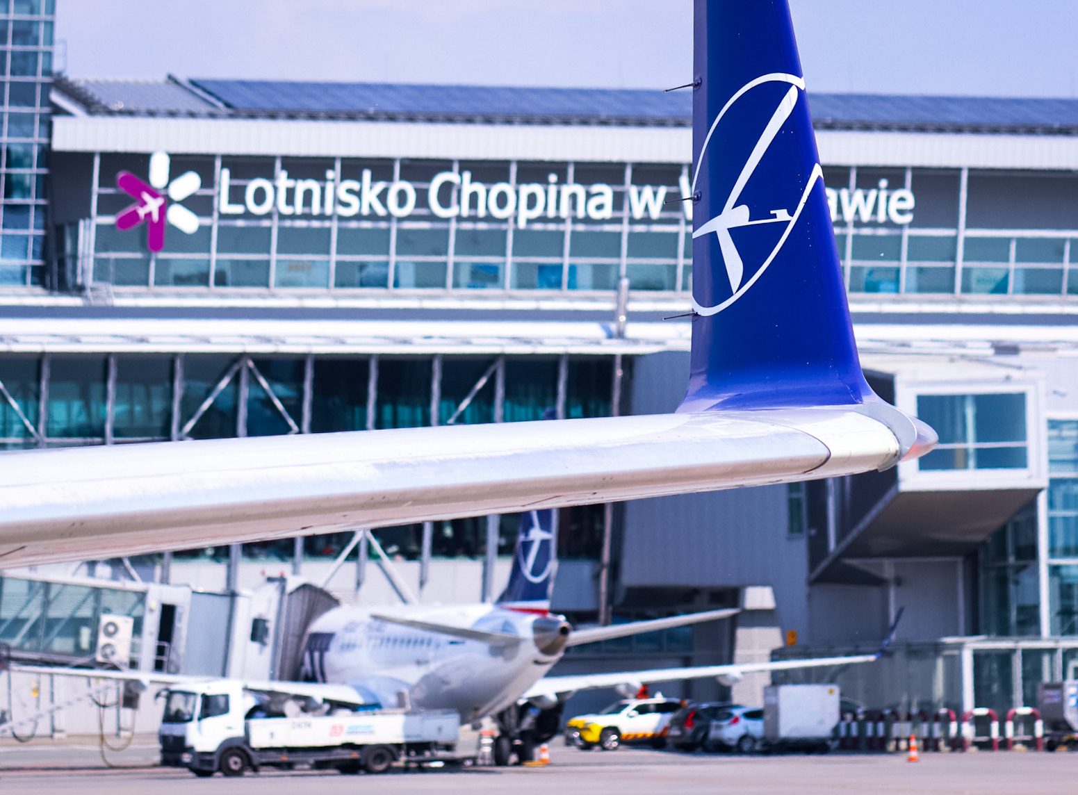 Chopin Airport terminal with view of planes on runway.