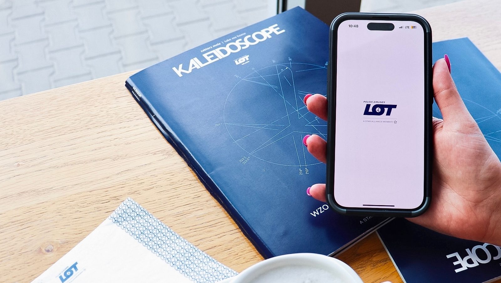 Person using the LOT app for online check-in at the airport.