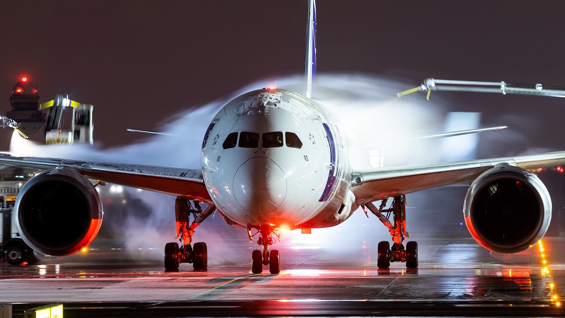 Boeing 787 Dreamliner during the night de-icing procedure of the aircraft