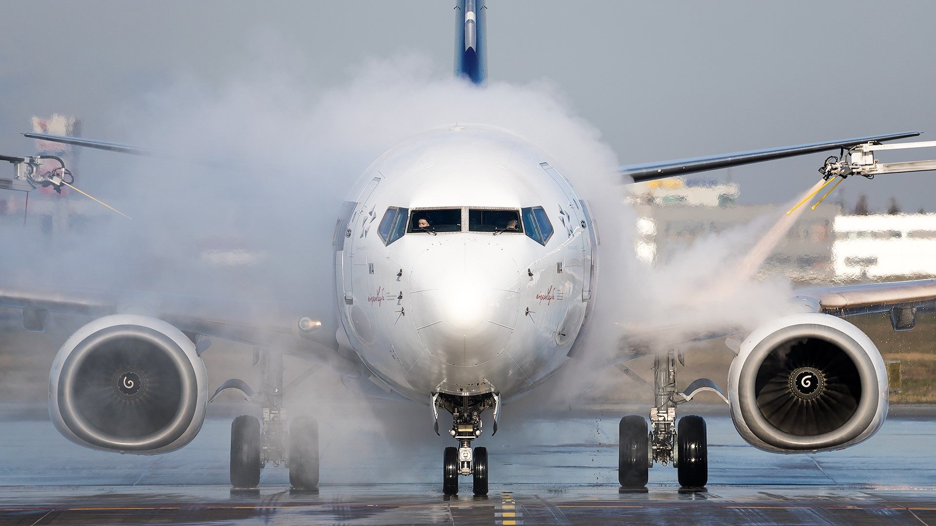 Boeing 737 MAX during the de-icing procedure during the day