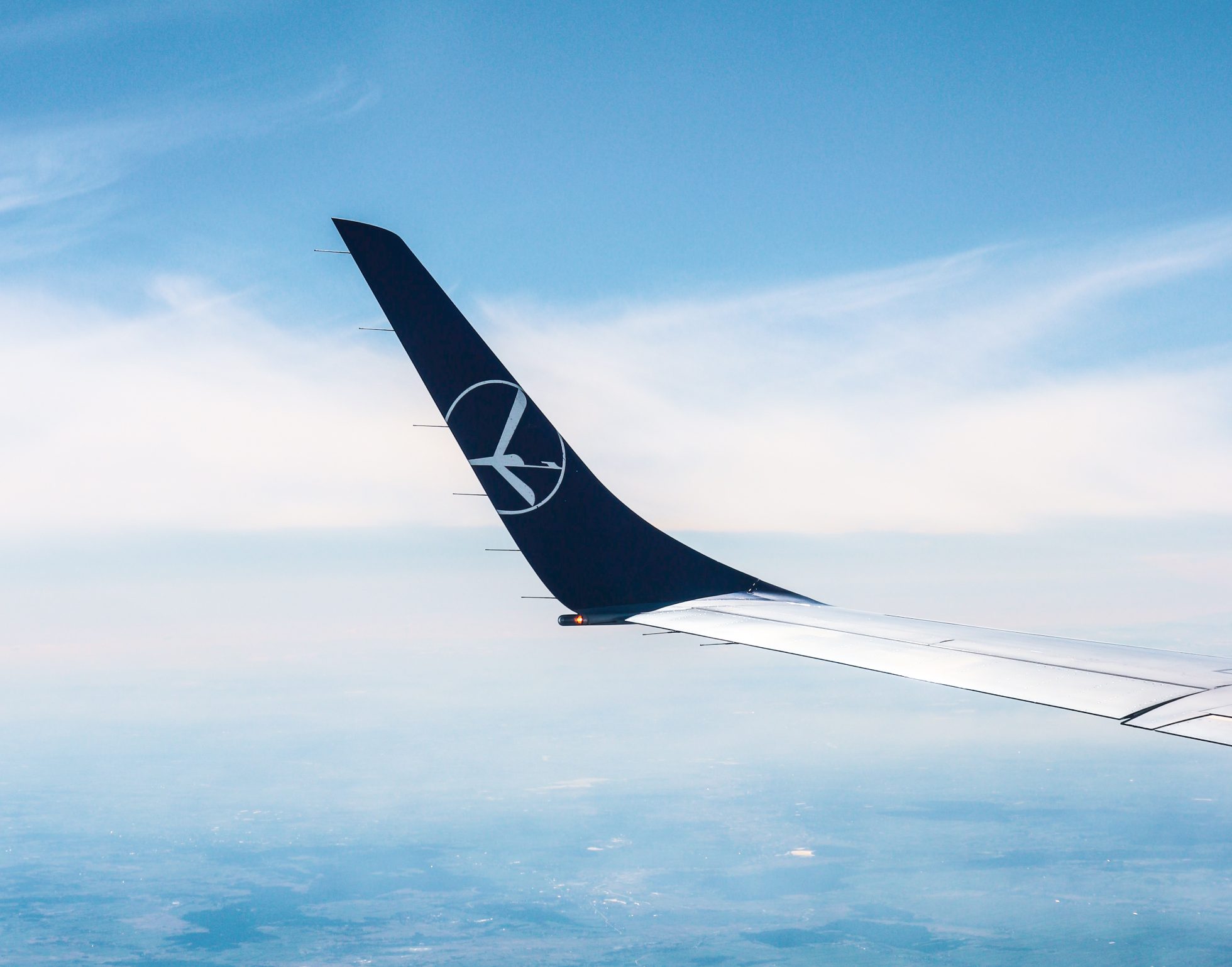 Embraer 195 wing during flight on a sunny day