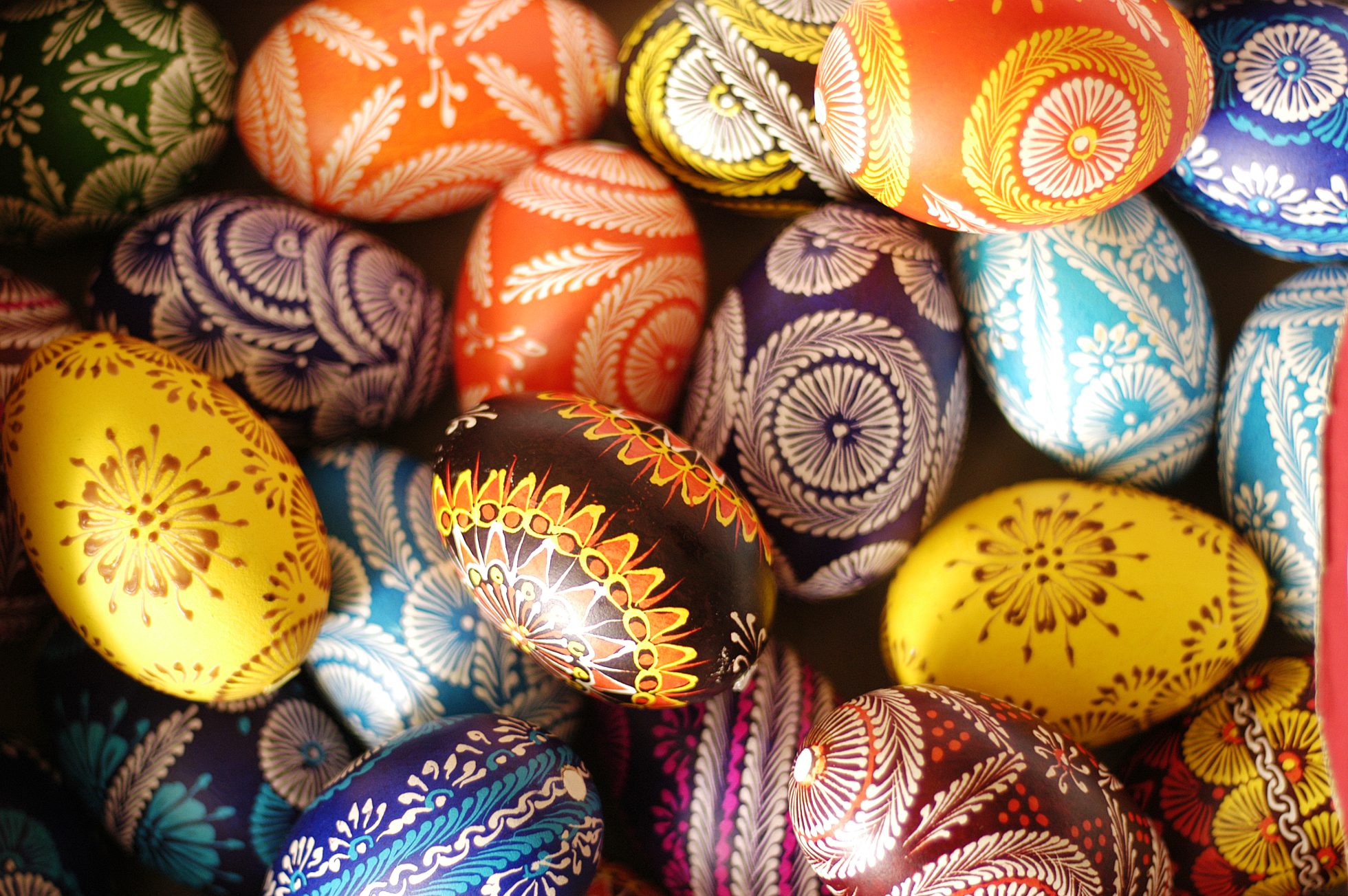 A group of children playing at Easter Egg Hunt, laughing and shouting, outside in the sunshine; Easter ideas