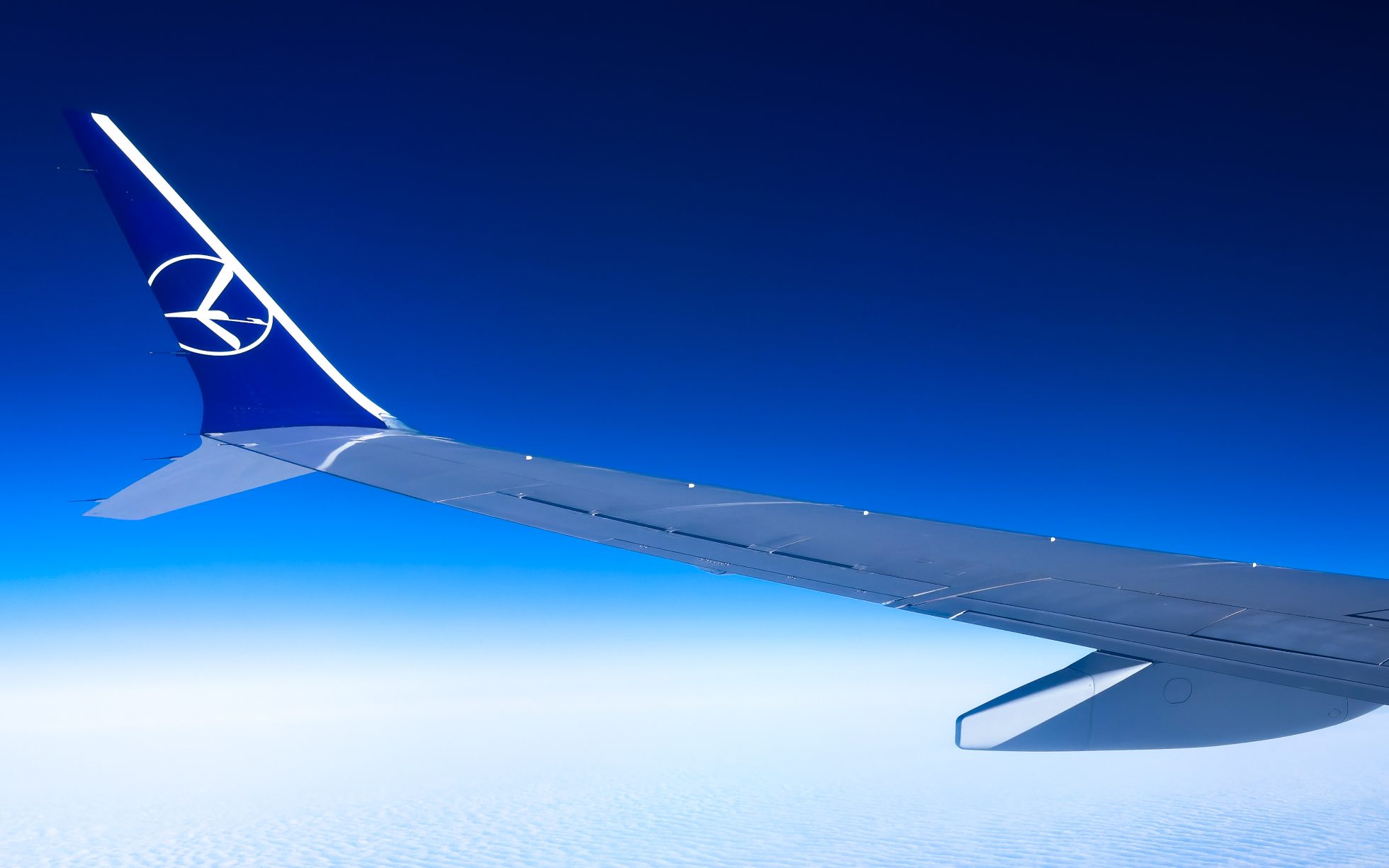 Boeing 737-8 MAX wing against the sky.