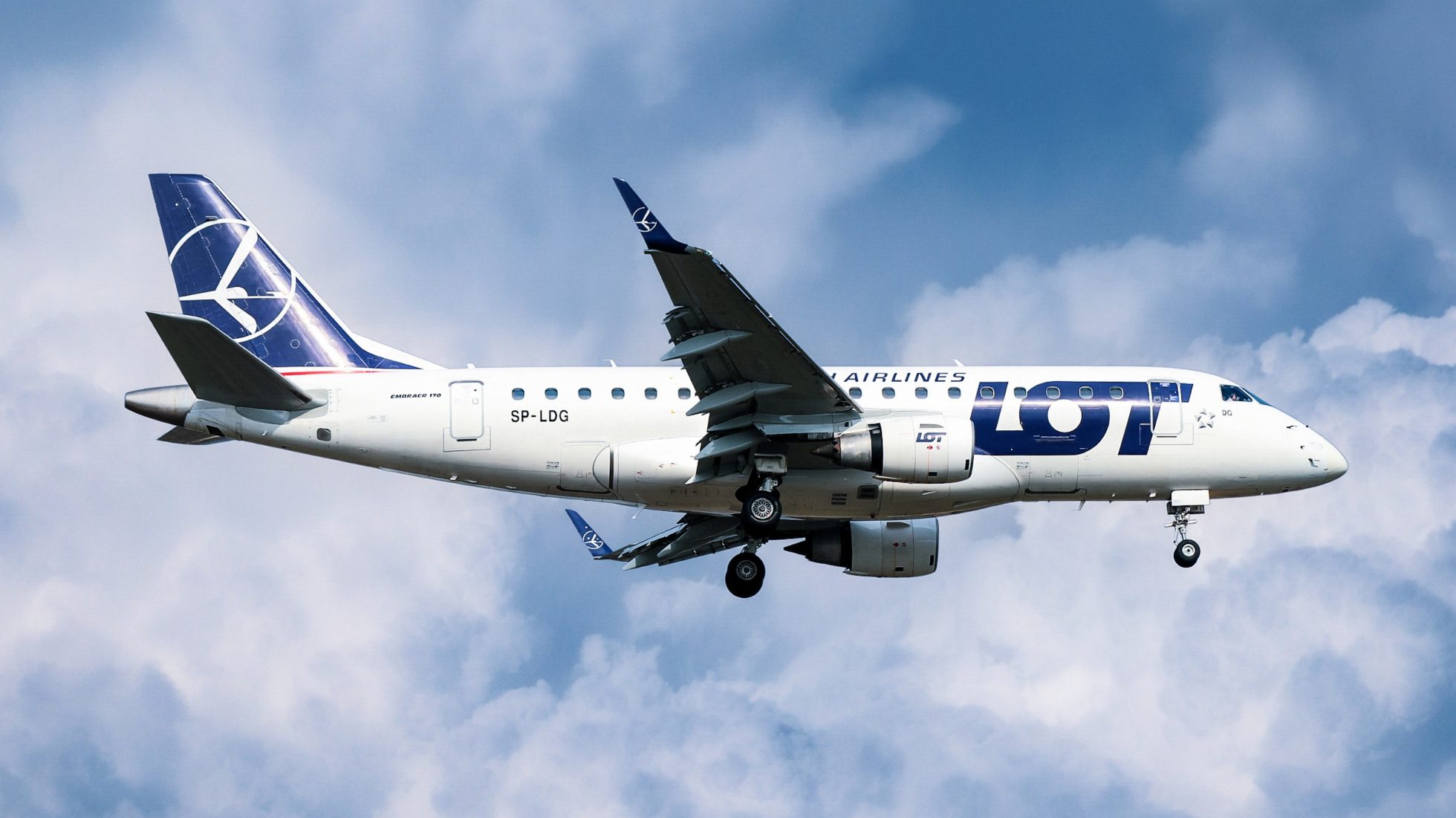 Embraer 170 aircraft approaching airport for landing.