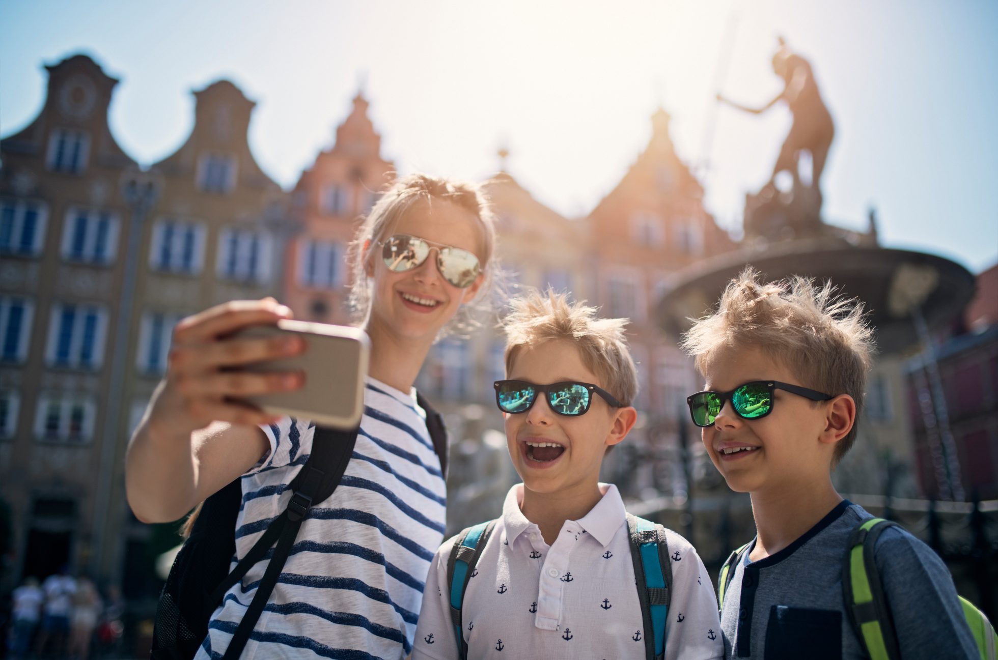 Kids tourist sightseeing Gdansk, Poland. They are taking selfies in front of the famous Neptune's Fountain.
Nikon D850