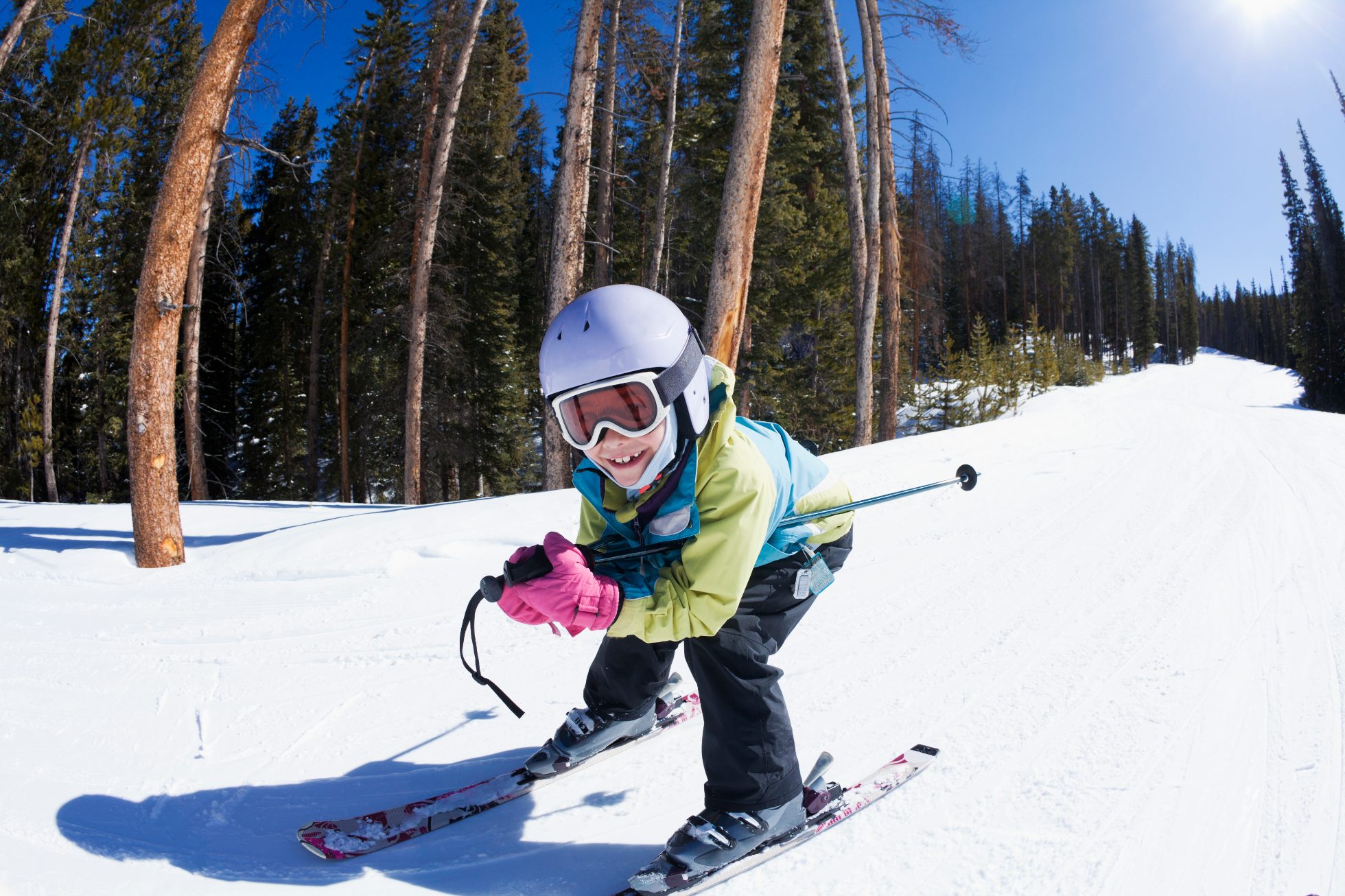 Child skis down on bent knees