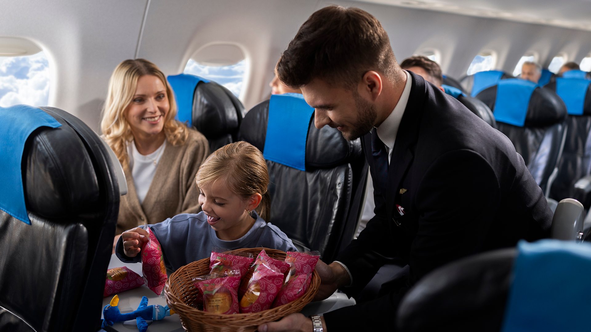 A child on board an Embraer treats itself to a piece of pastry